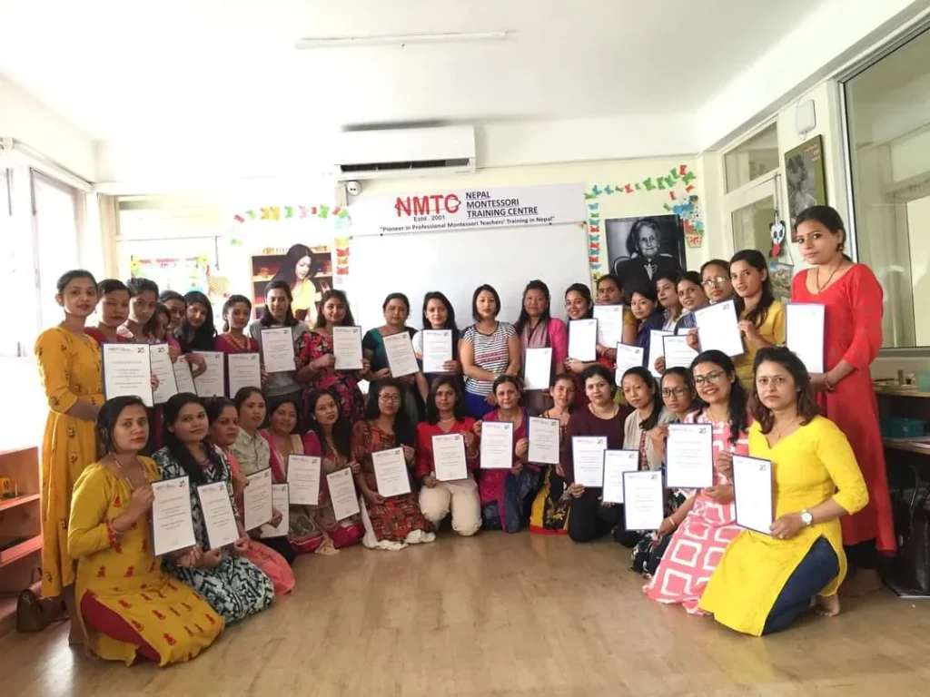 NMTC trainees holding their certificates in the training room