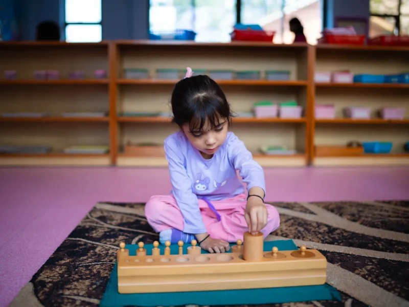 Girl working with the knobbed cylinders