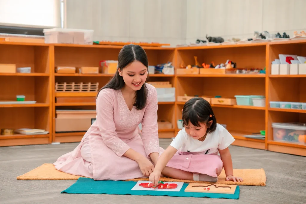 Teacher and child matching cards on a mat
