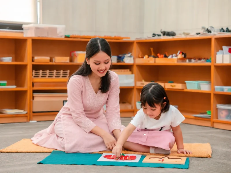 Teacher and child matching cards on a mat