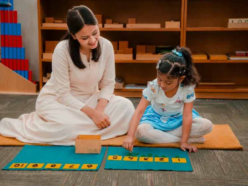 Teacher and child working with sandpaper letters