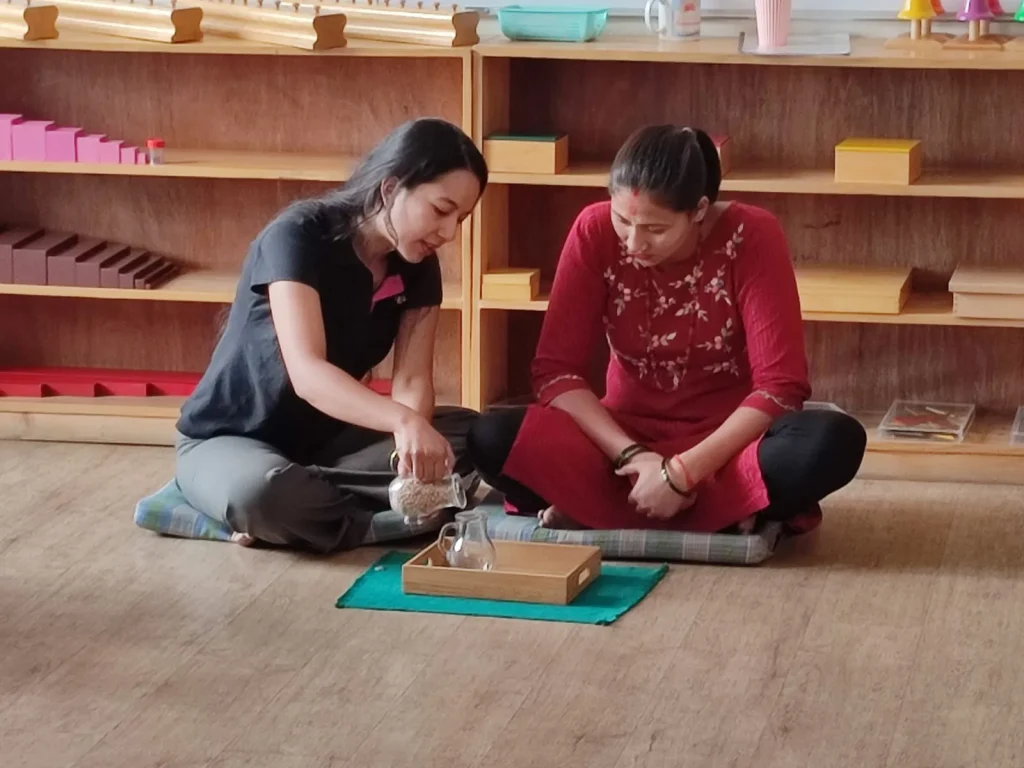 NMTC trainees practising with Montessori materials on floor mats